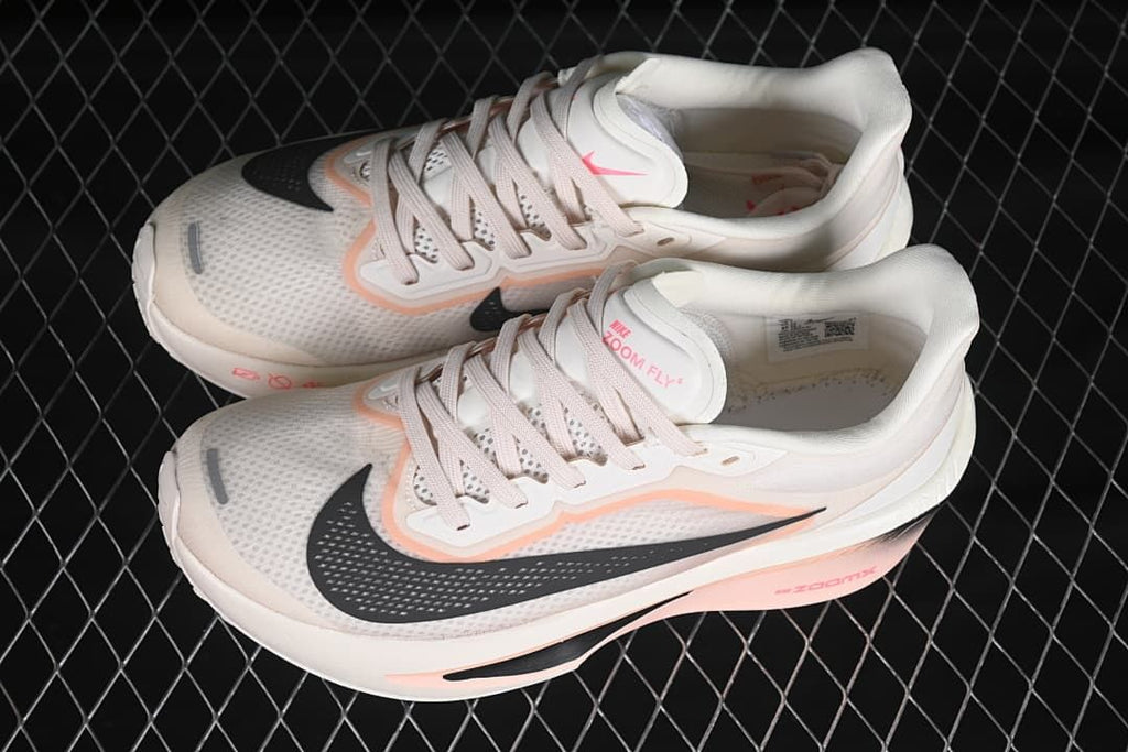 Pair of white and pink Nike Zoom Fly 6 shoes shown from above
