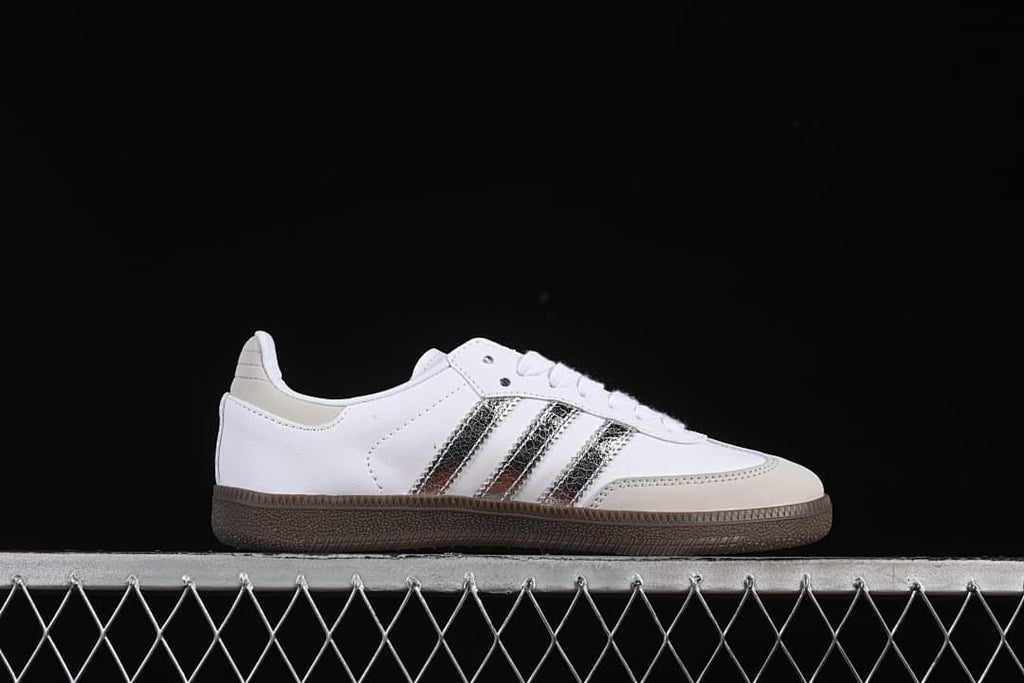 Side profile highlighting the white upper, silver stripes, and brown sole