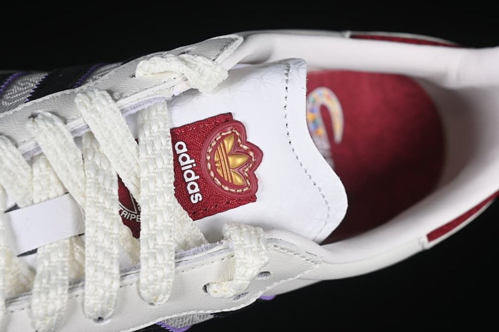 Top close-up of white laces and tongue with adidas branding