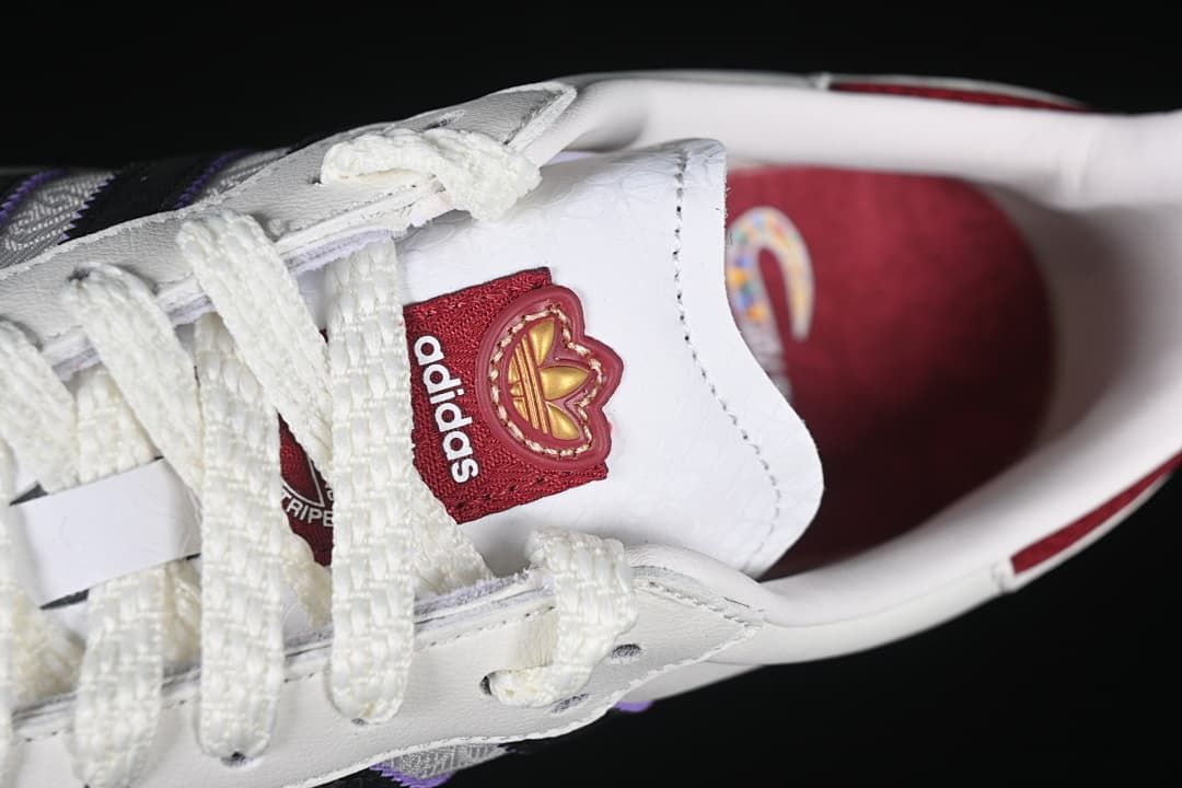Top close-up of white laces and tongue with adidas branding
