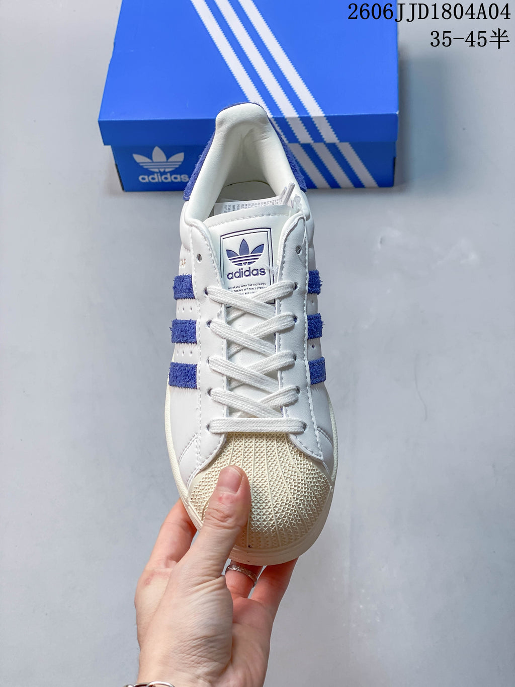 Front view showing the laces, blue stripes and textured shell toe