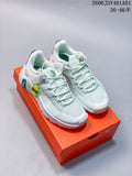 Pair of white Nike Free Metcon 7 training shoes with pale mint and green details on an orange shoebox.