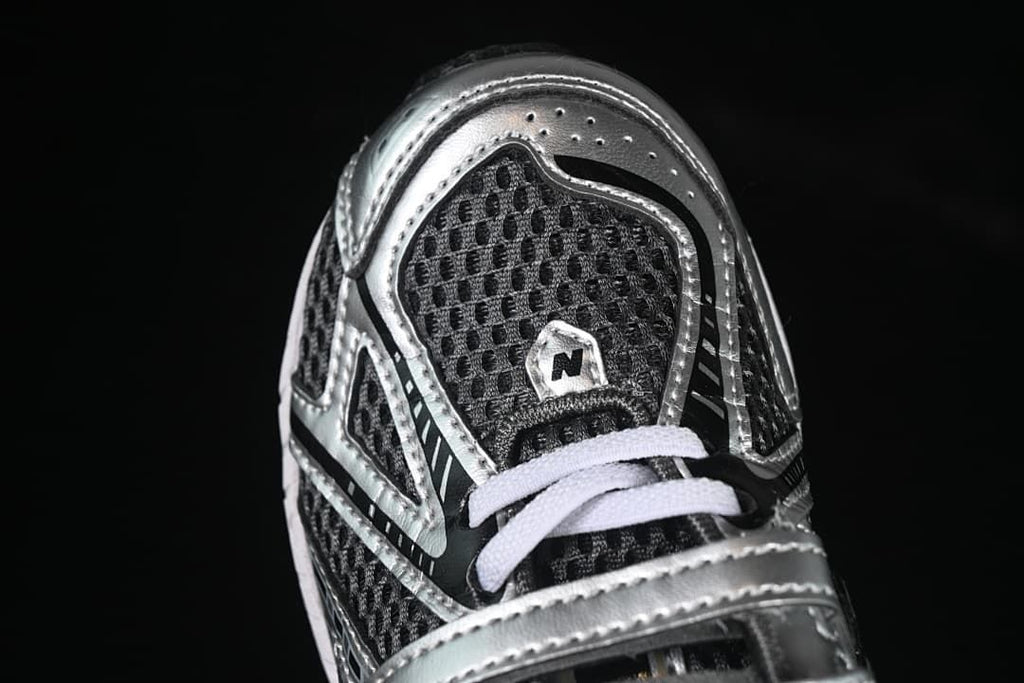 Top-front close-up showing the mesh-look toe, silver overlays, and white laces