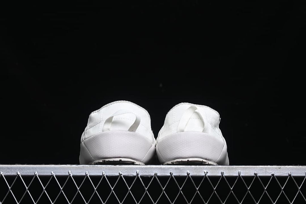Rear view of both slippers showing their heel pull loops.