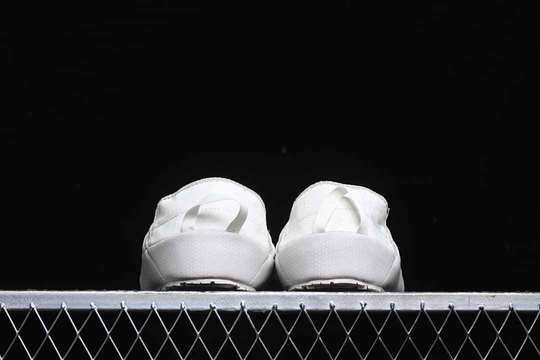 Rear view of both slippers showing their heel pull loops.