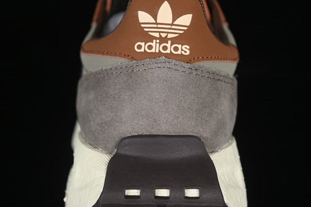 Rear view of the sneaker with brown heel tab and grey panels