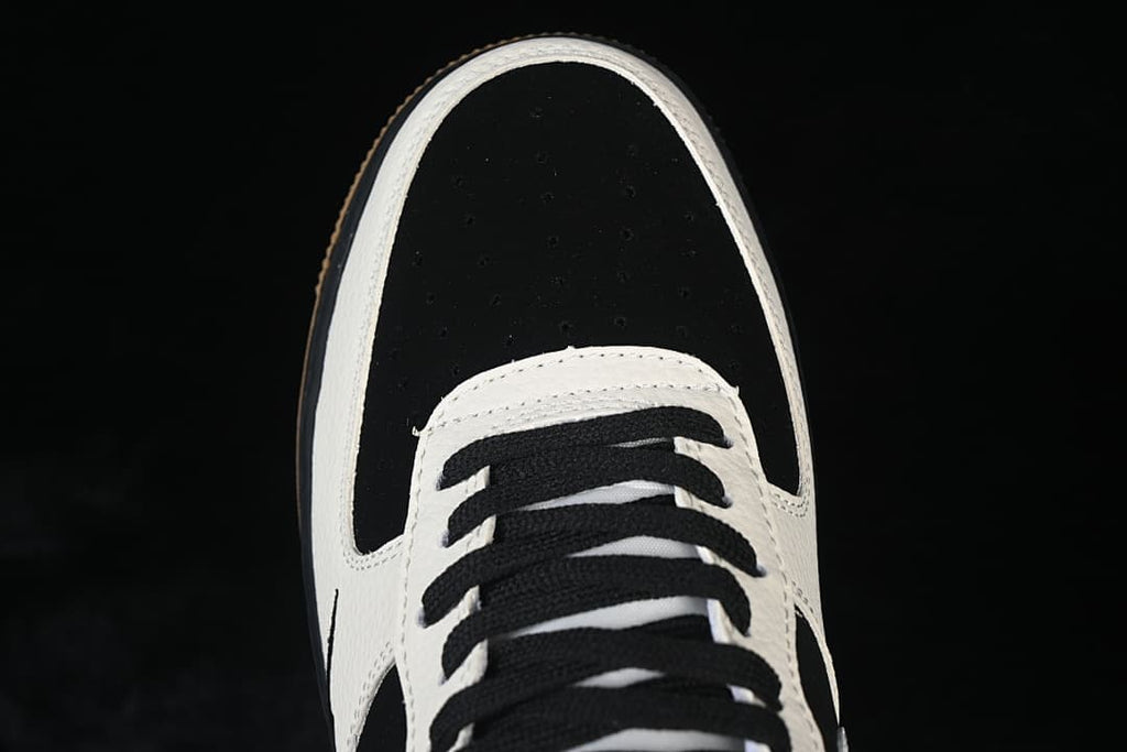 Top view of the black perforated toe and black laces on the low-top sneaker