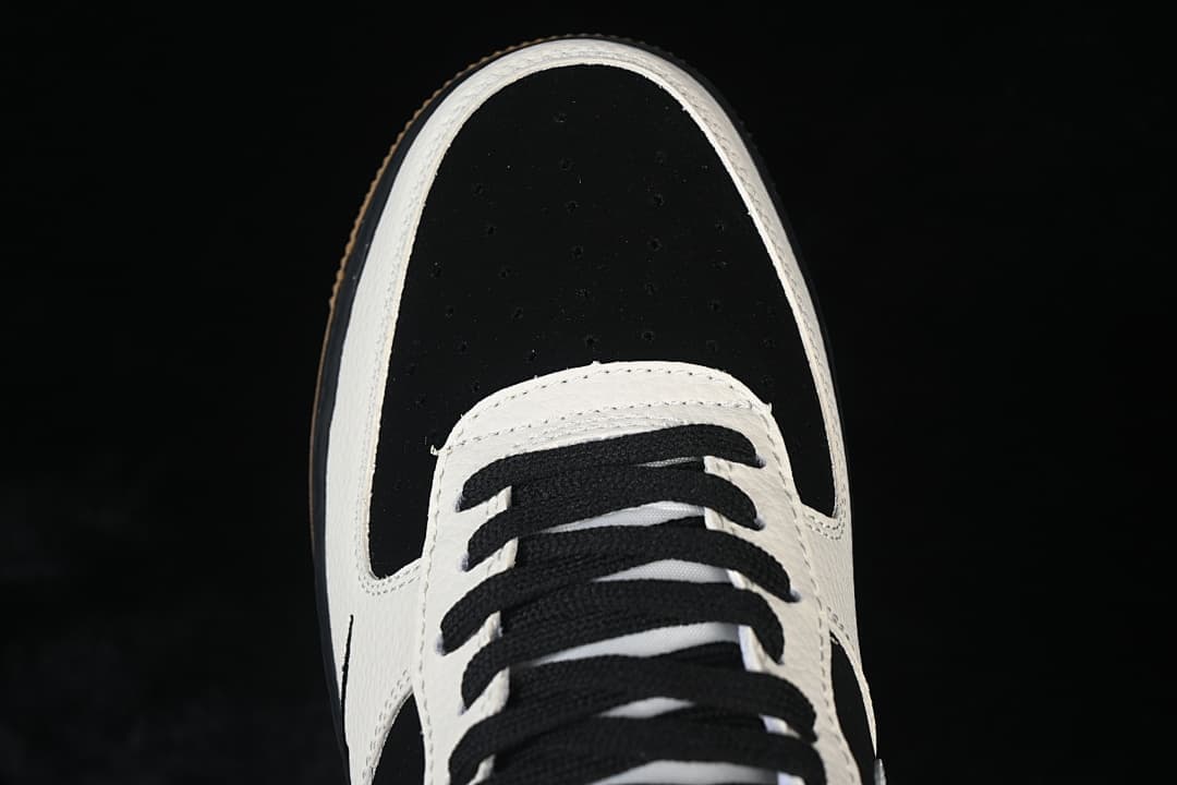 Top view of the black perforated toe and black laces on the low-top sneaker