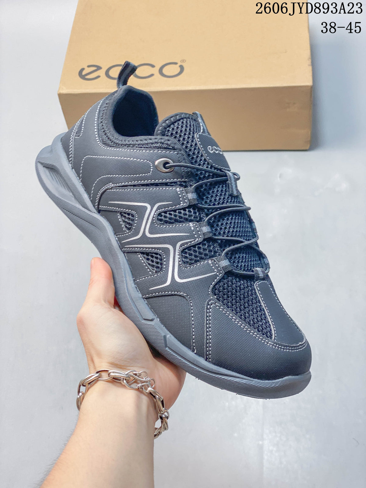 Angled side view of a gray ECCO Sko shoe with mesh panels and thick outsole