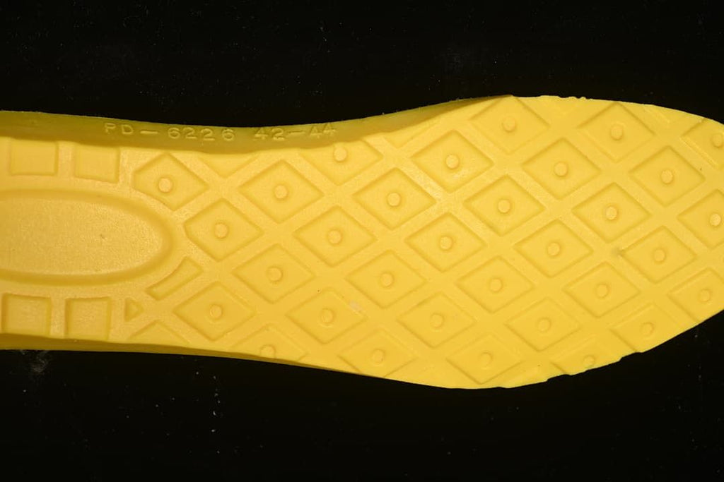 Close-up of the boot's yellow patterned outsole