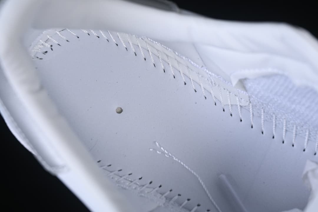 Close-up of stitching and interior lining of a white sneaker