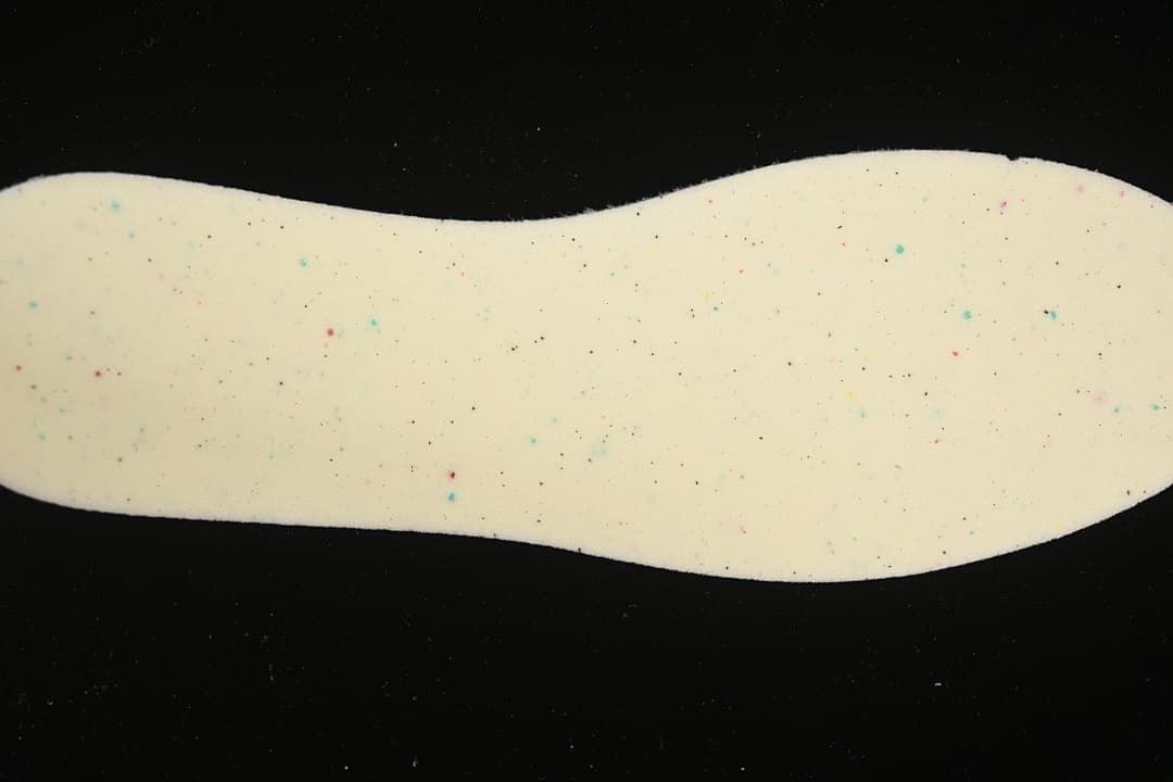 Close-up of a pale insole with small colored speckles