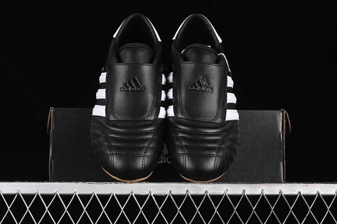 Front view of the pair showing stitched toes, fold-over straps, and white stripes.