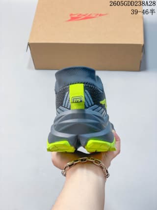 Rear view of the gray trail shoe with neon yellow-green outsole details