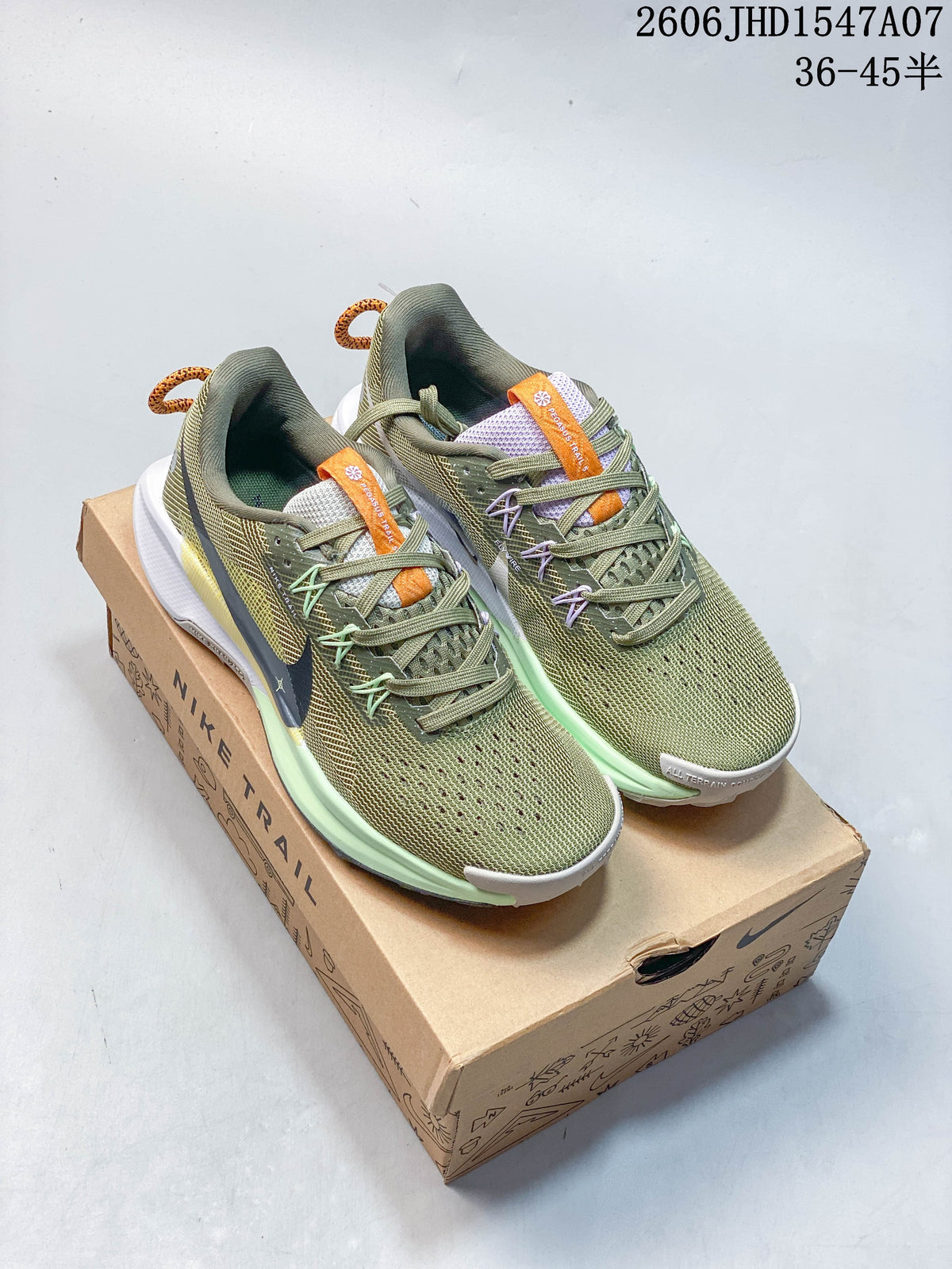 Pair of olive green Nike Pegasus Trail shoes displayed on a Nike Trail box.