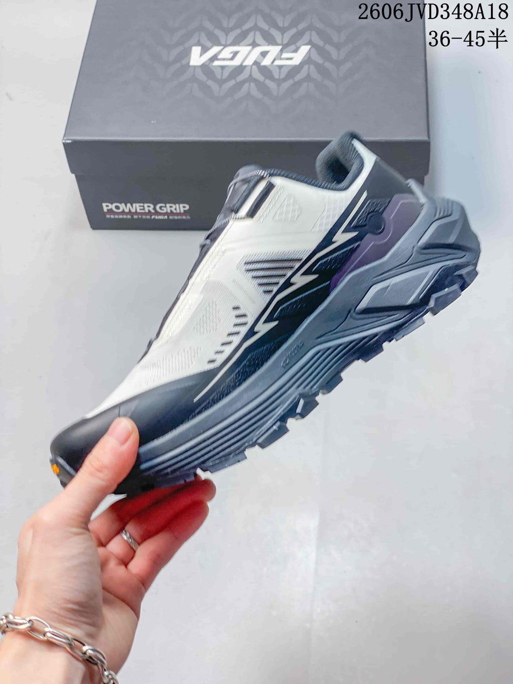 Side view of a white and gray FUGA EX3 trail running shoe