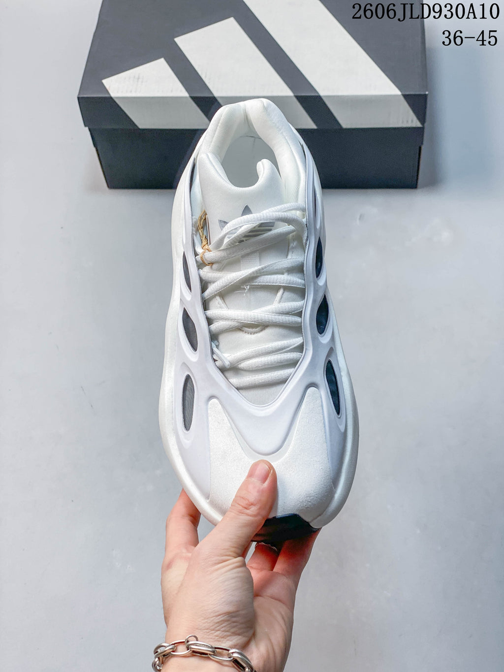 Top view of the white adidas Hyperboost sneaker with laces and sculpted side panels.