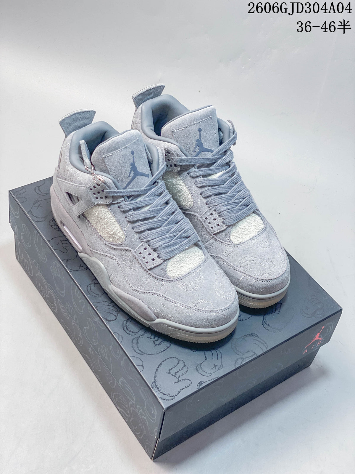 Pair of grey Air Jordan 4 Retro mid-top sneakers displayed on a patterned shoe box