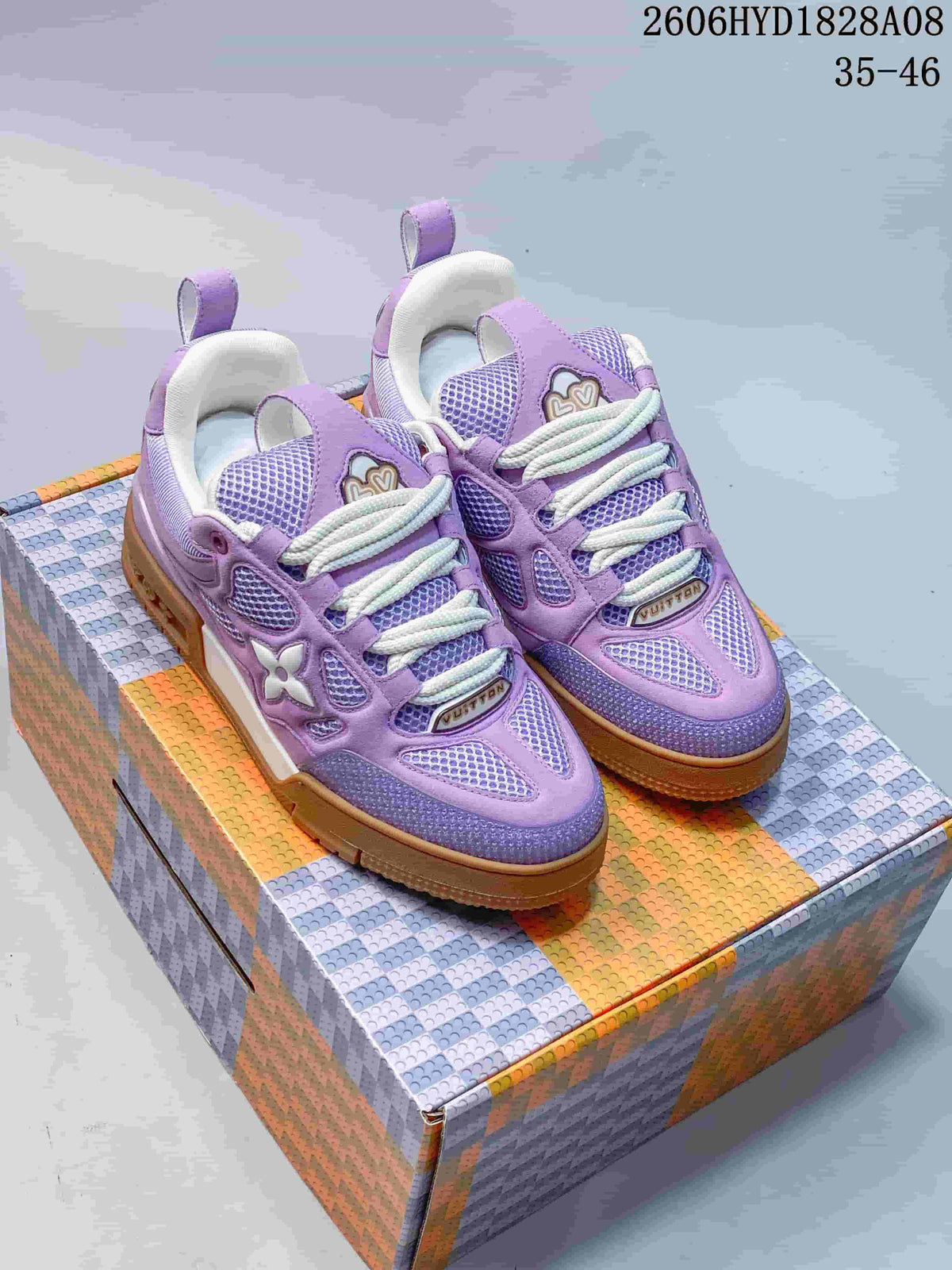 Pair of lavender Trainer-style sneakers with white laces and gum-colored soles, shown from the front