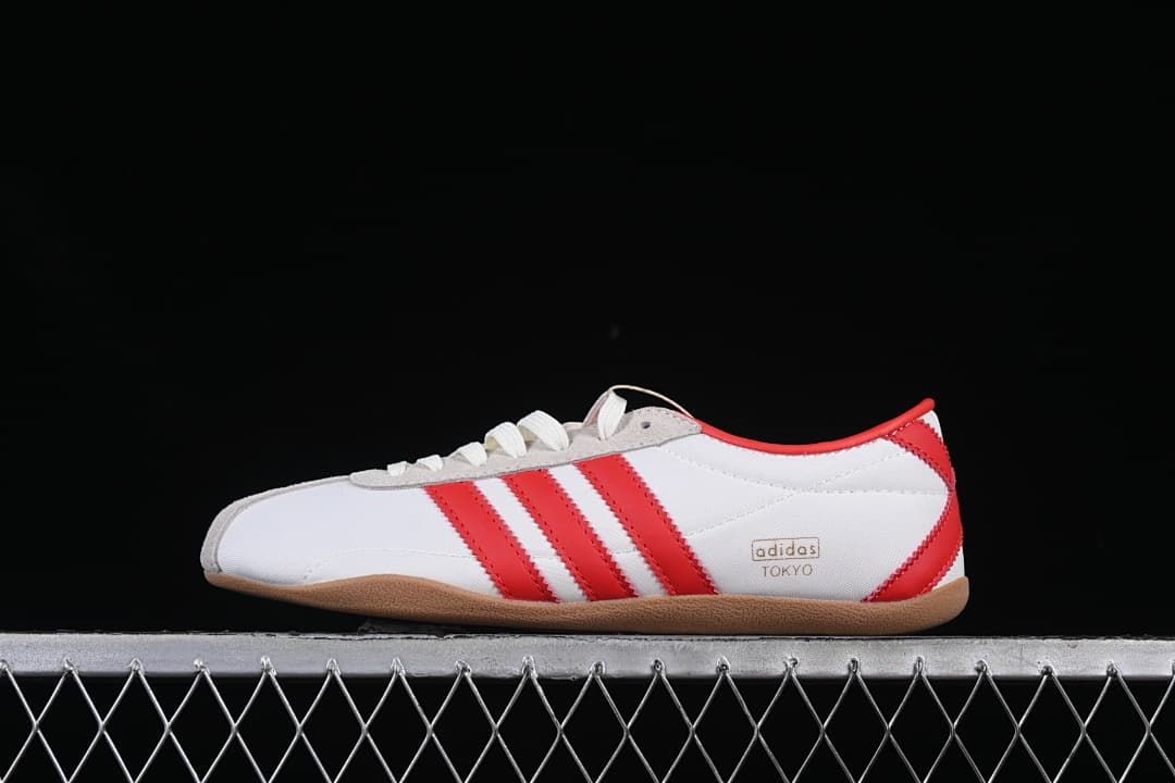 Side view of the white adidas Tokyo sneaker with red stripes