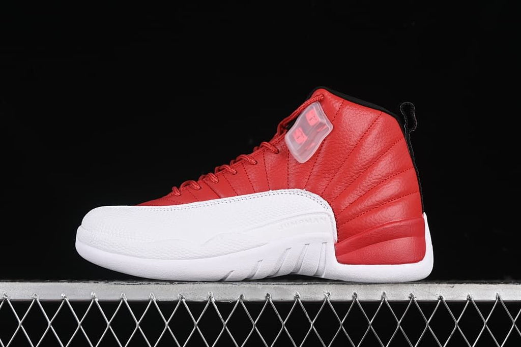 Side view of a red, white, and black Air Jordan 12 high-top sneaker