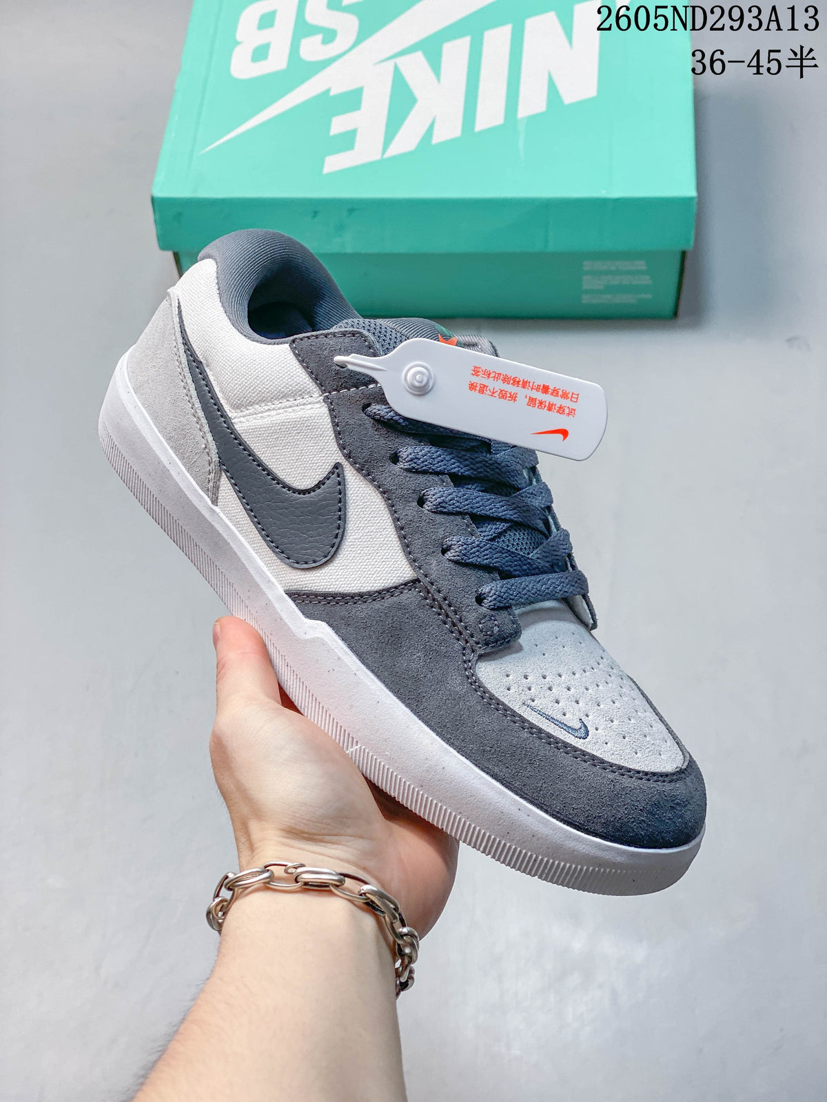 Gray and navy Nike SB Force 58 shoe with a light blue perforated toe