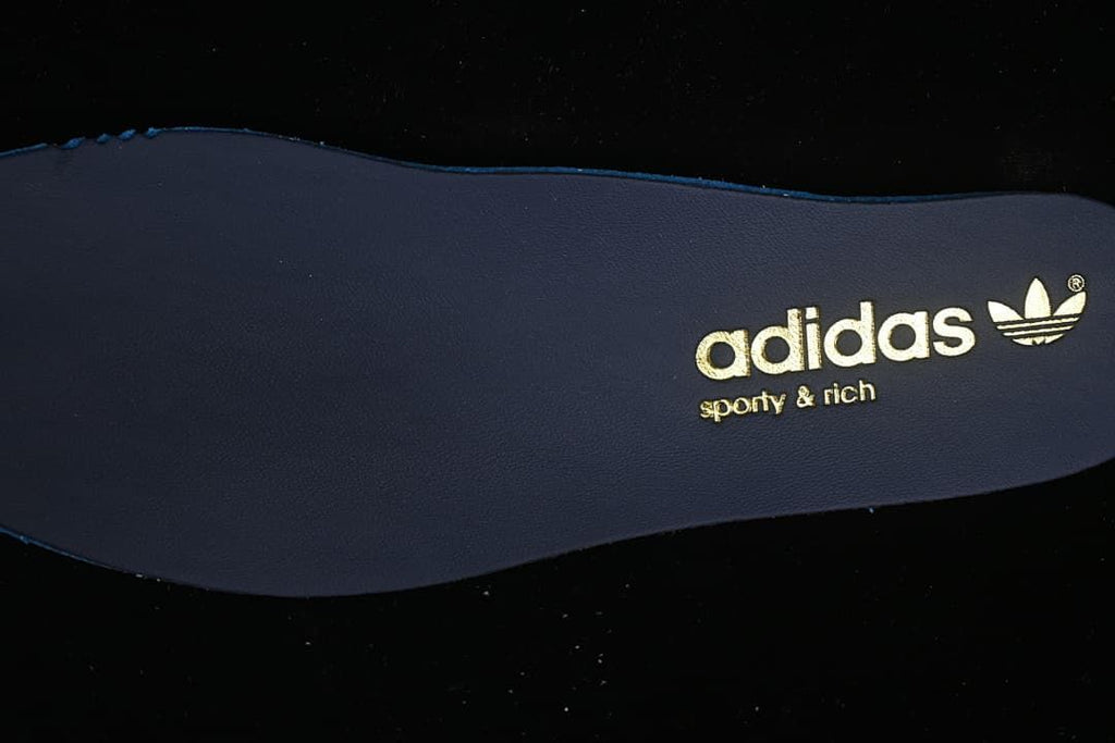 Close-up of the dark insole with adidas and Sporty & Rich branding