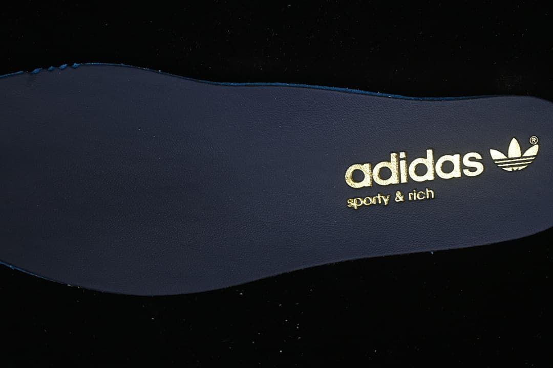 Close-up of the dark insole with adidas and Sporty & Rich branding
