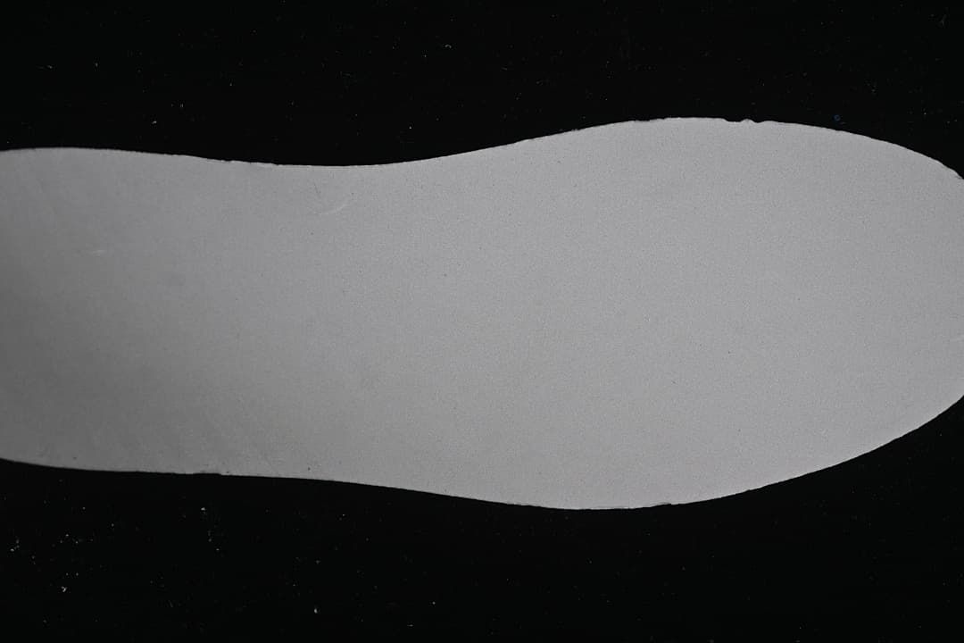 Close-up of a light-colored shoe sole against a dark background