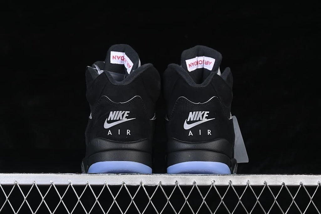 Rear view of the pair showing Nike Air heel branding and icy blue outsole sections