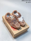 Pair of brown-toned New Balance 530 SL sneakers on a branded box, showing contrasting lace details.