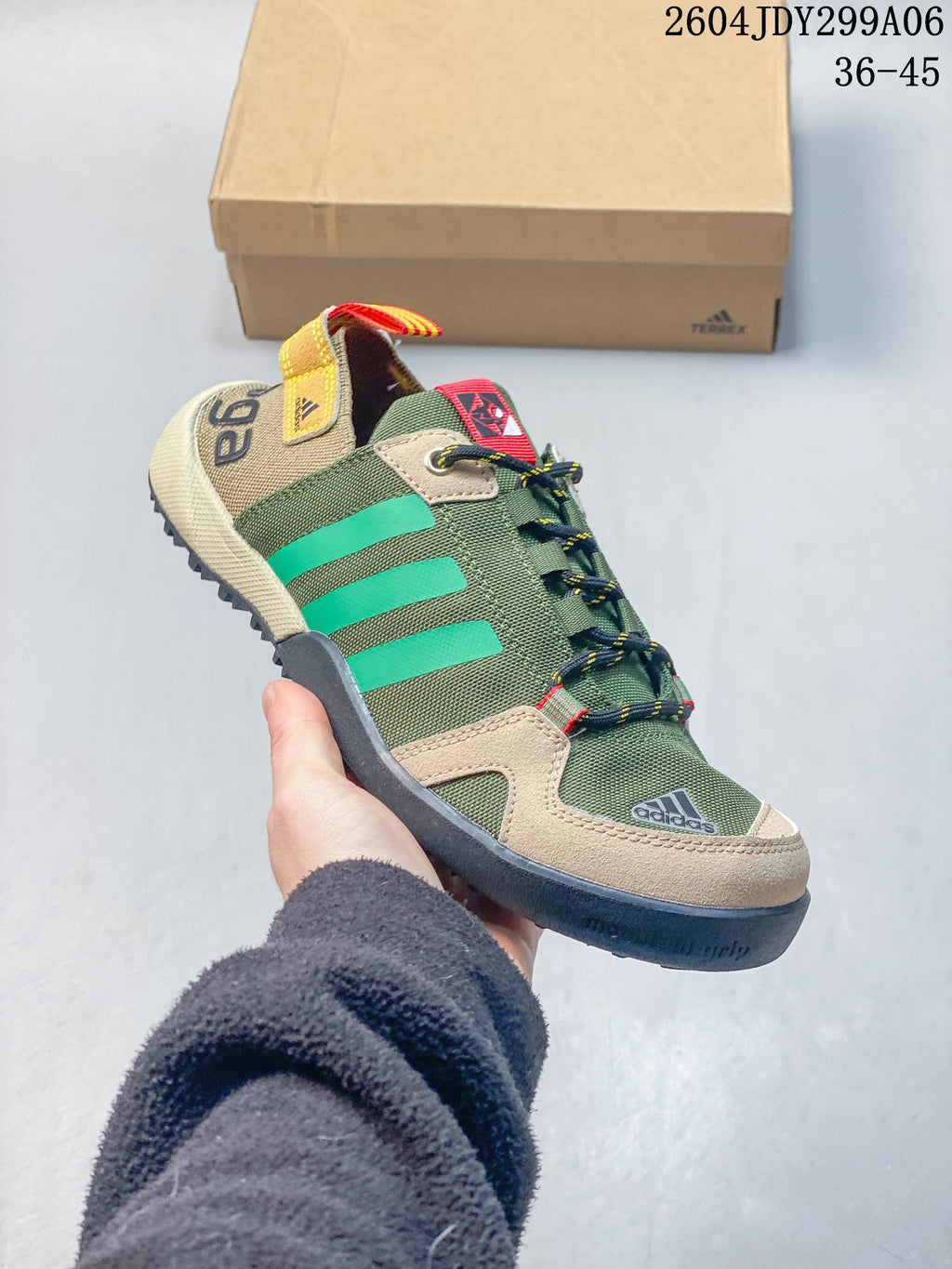 Angled view of the shoe showing its green upper, beige panels and dark tread