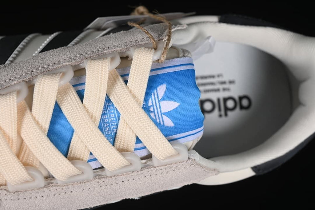 Close-up of the blue tongue label and cream laces.