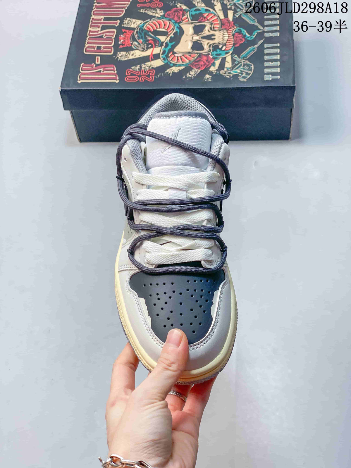 Front view highlighting the perforated toe and layered laces of an Air Jordan 1 Low sneaker.