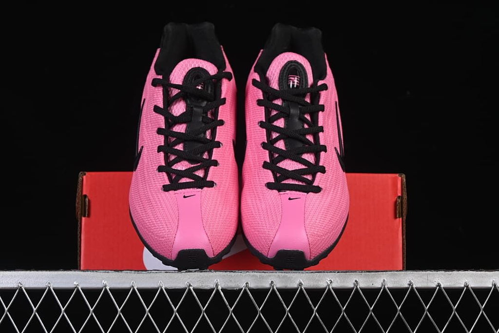 Front view of the pair showing pink uppers and black laces