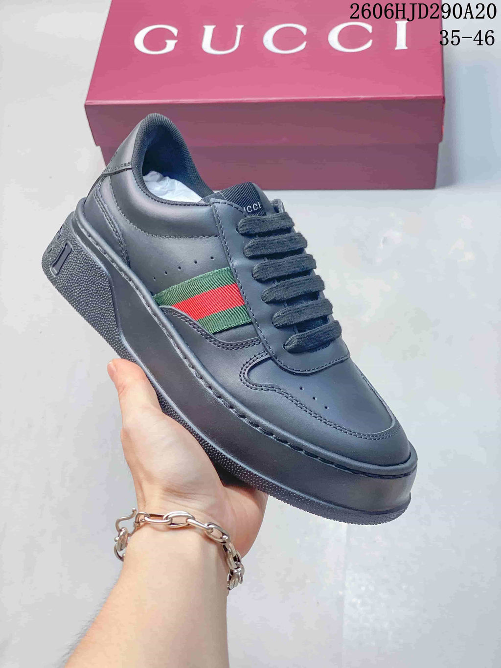 Charcoal low-top sneaker with dark laces and green-and-red side stripe