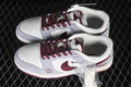 Pair of gray, white, and burgundy Nike SB Dunk Low sneakers shown from above