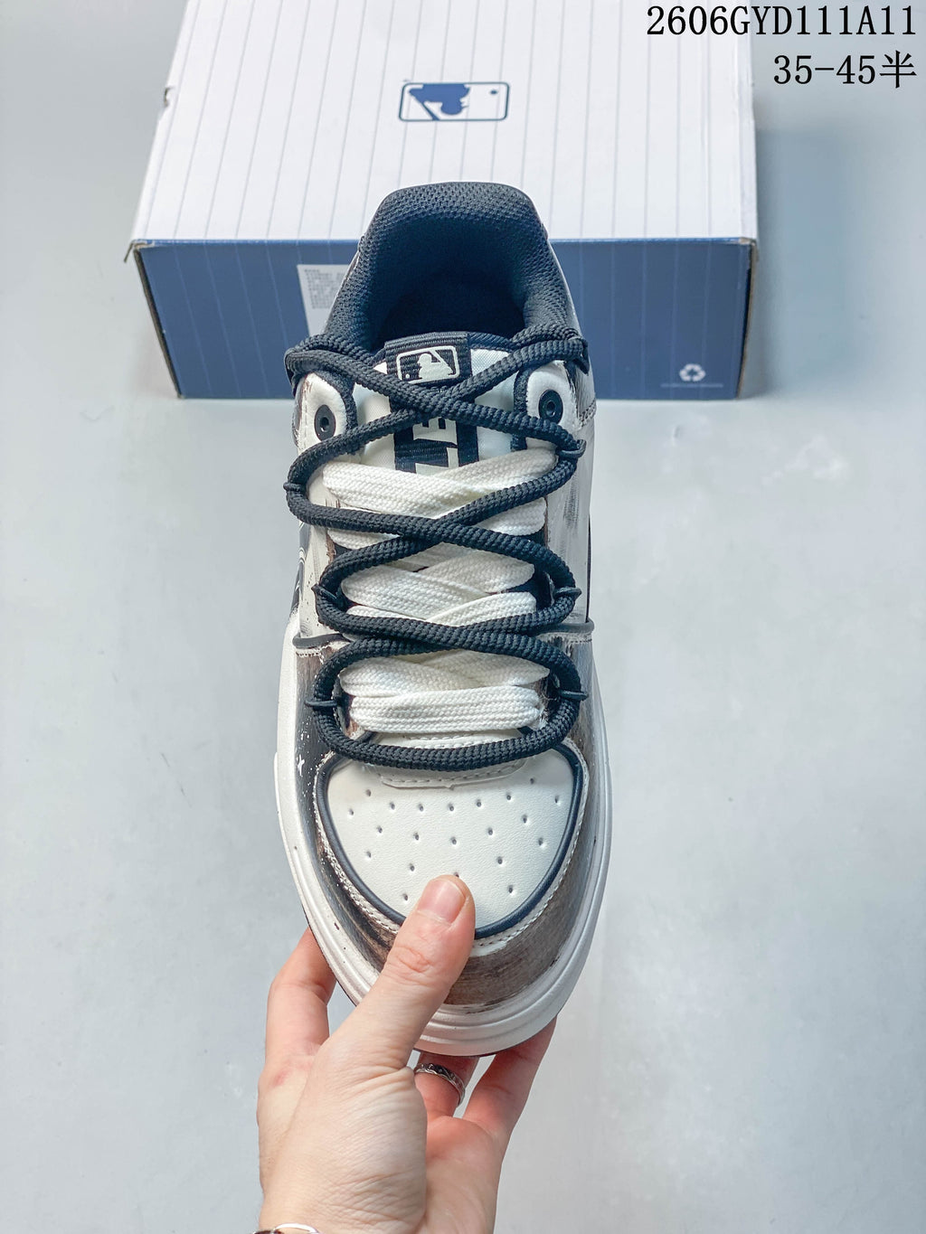 Top view showing the perforated toe, layered laces, and navy tongue.