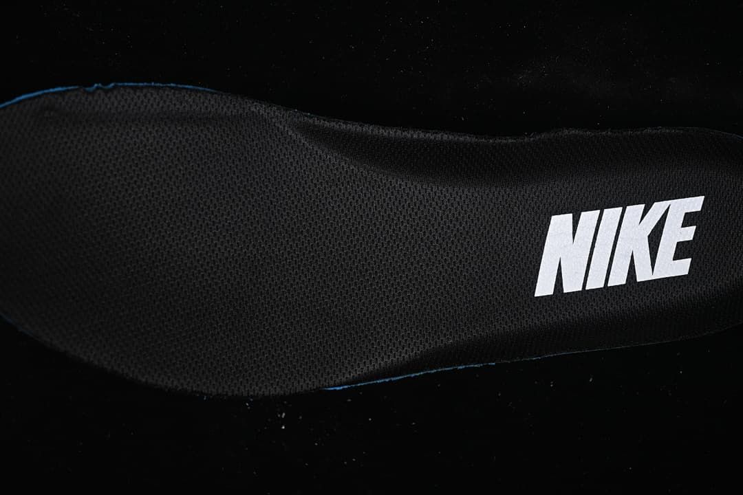 Close-up of a black fabric shoe insert with Nike branding.