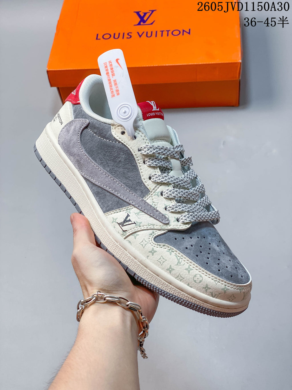 Angled side view of a grey and off-white low-top sneaker with red accents