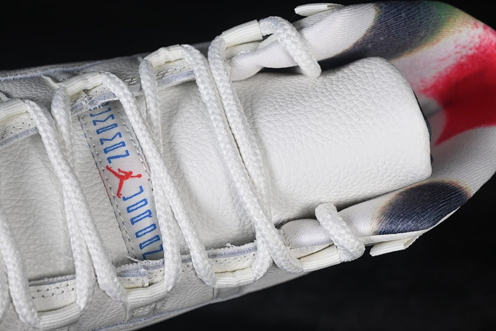 Top view of the padded tongue, white laces, and multicolor collar lining.
