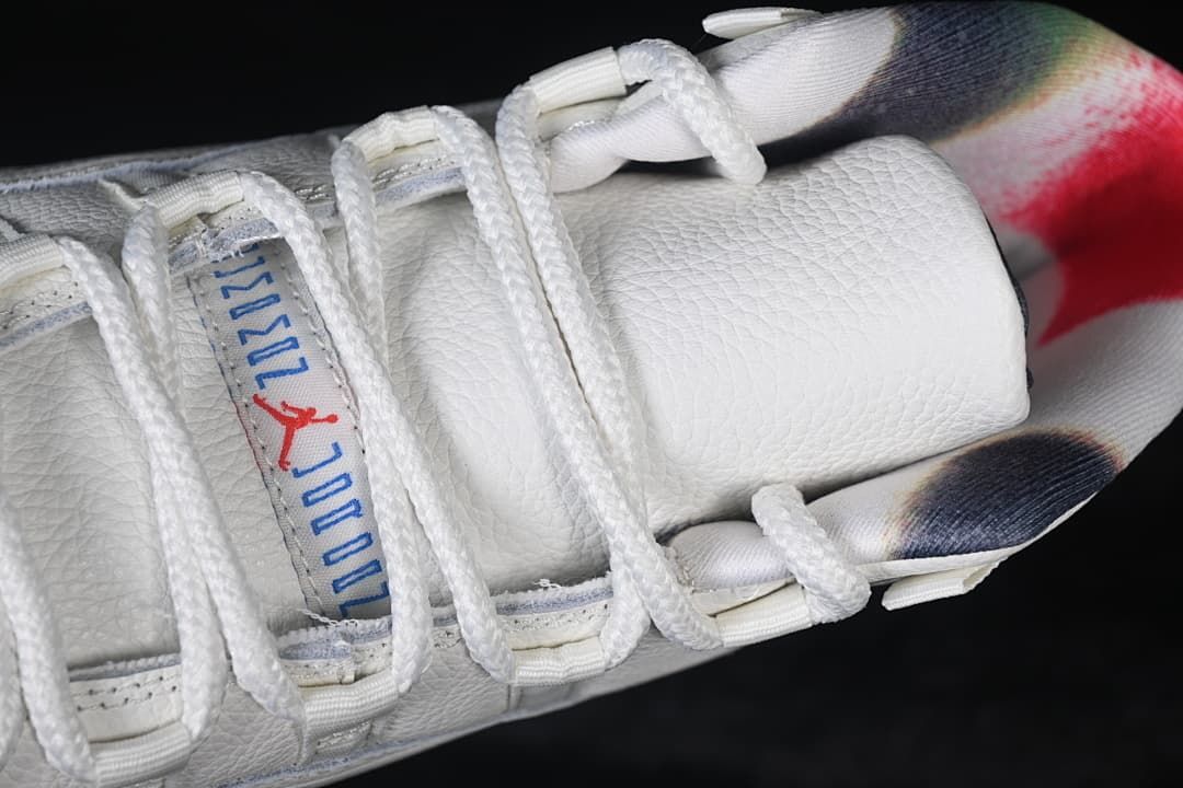 Top view of the padded tongue, white laces, and multicolor collar lining.