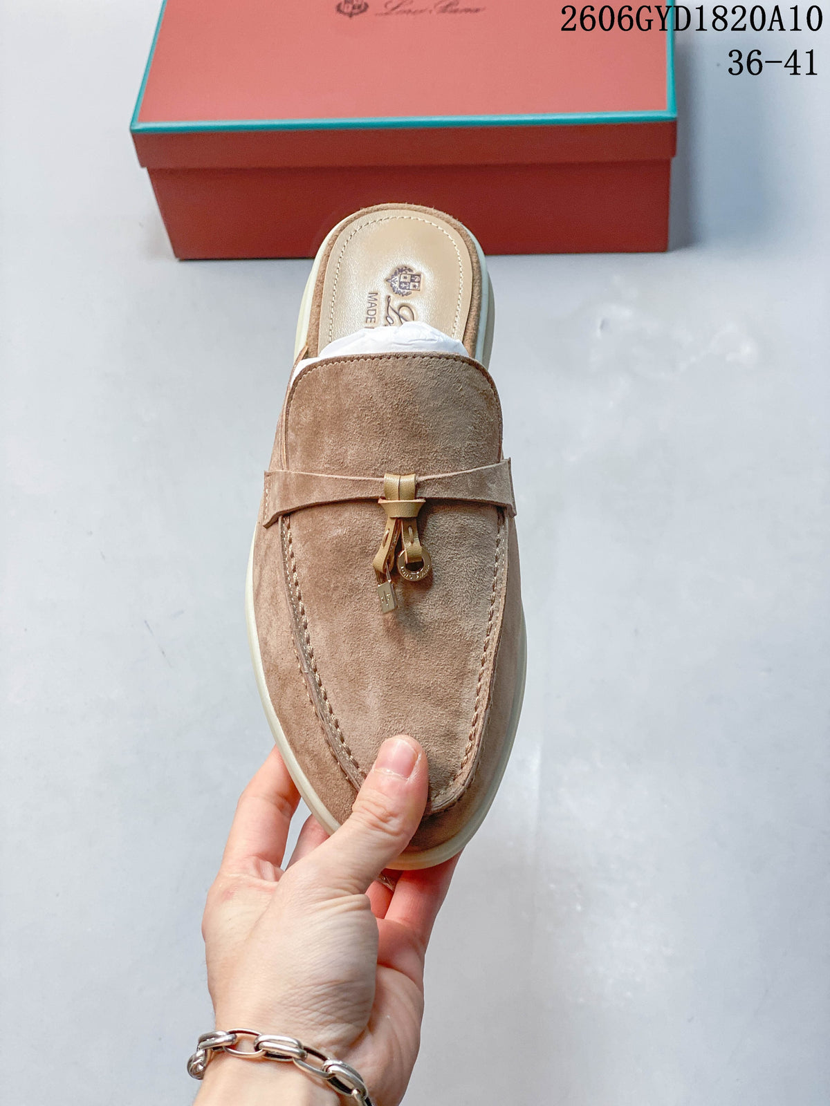 Top view of a taupe loafer mule with a decorative metal vamp detail