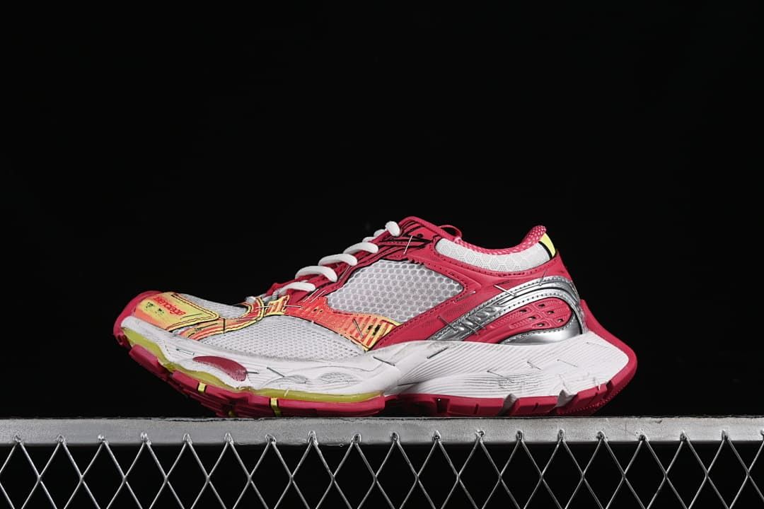 Side view of multicolor Balenciaga Stapler running sneakers against a dark background