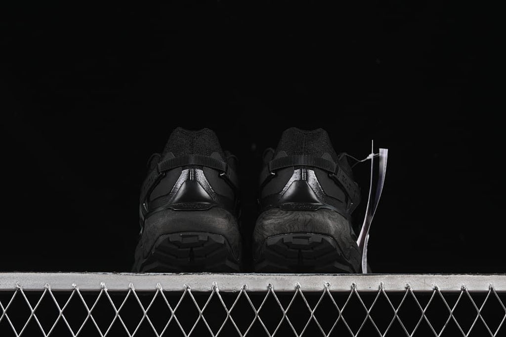 Rear view of both shoes showing the heel and tread
