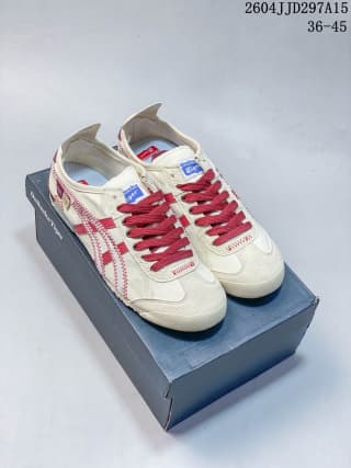 Pair of white and red sneakers displayed on top of an Onitsuka Tiger shoe box.