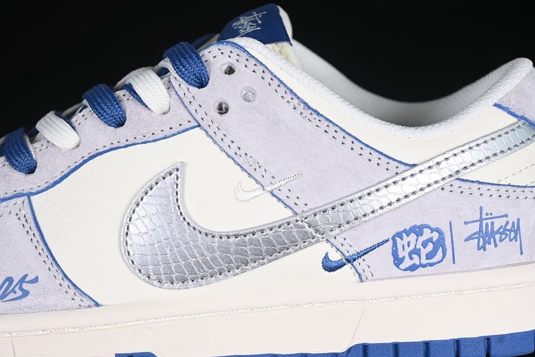 Close-up of the side panels, metallic patterned Swoosh, blue trim, and decorative graphics