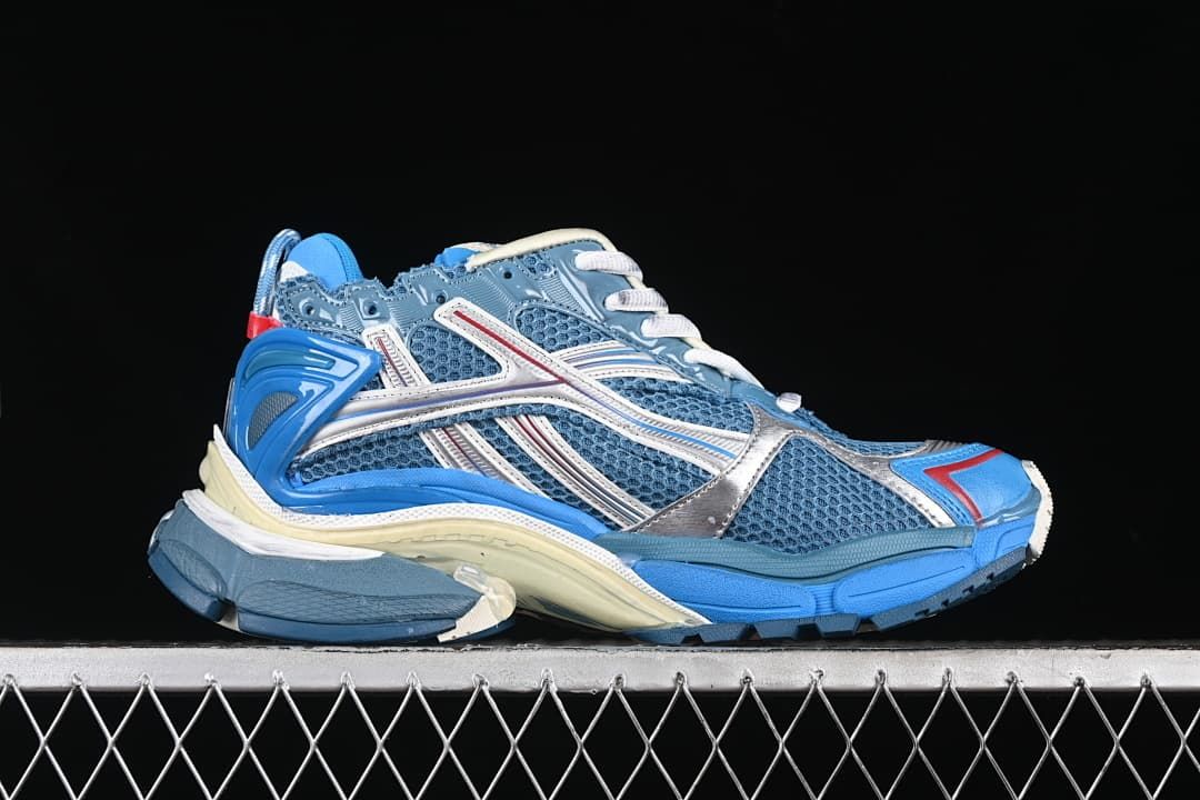 Side profile of the sneaker with blue mesh and silver-toned overlays