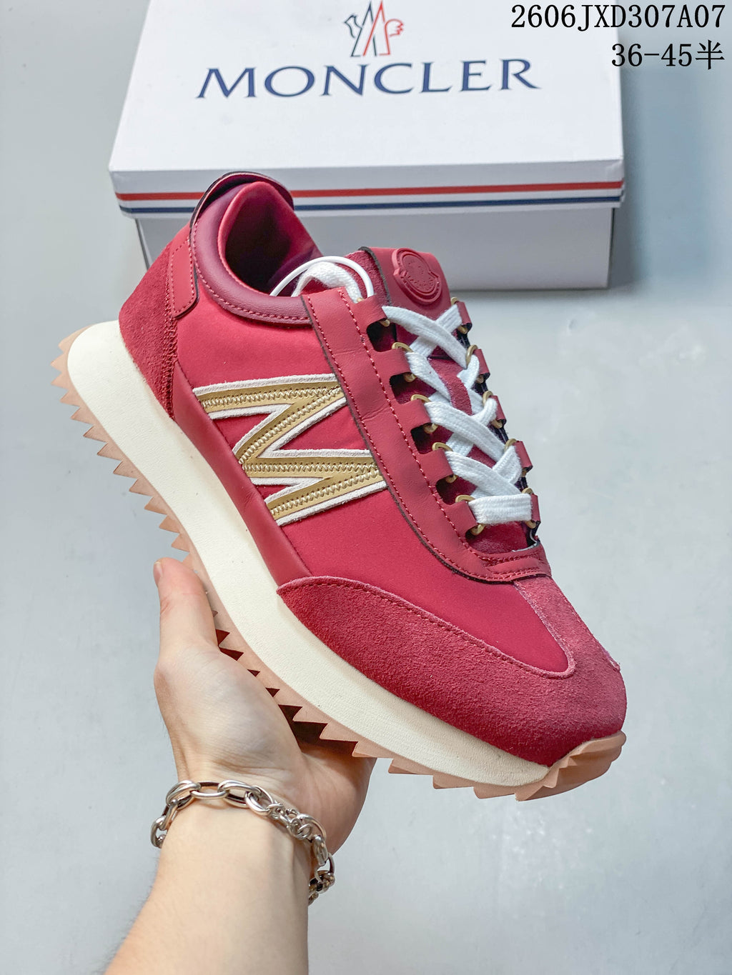 Side view of a rose-pink sneaker with a gold-tone accent, cream midsole, and sawtooth outsole.