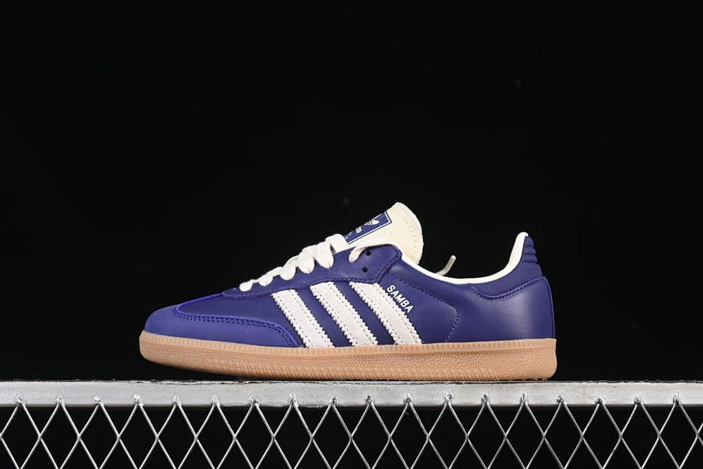 Side view of purple adidas Samba OG sneakers with white stripes and gum-colored soles